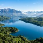 Exploring Lake Tuba: Top 5 Must-See Destinations (2025 Guide) A breathtaking wide aerial view of Lake Tuba surrounded by lush green hills, dense untouched forests, and distant majestic mountains under a clear blue sky, inviting exploration.