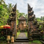 A serene Balinese temple gate framed by lush tropical foliage in Ubud.