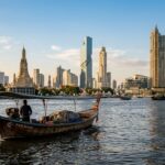 A Bangkok canal scene with a longtail boat passing traditional wooden houses.