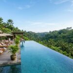 A serene infinity pool overlooking a lush, tropical valley in Ubud, Bali.