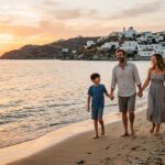 Family Holiday Guide to Greece 2025: Best Islands, Tips & Resorts A family with two children walking hand-in-hand along a scenic Greek beach at sunset.