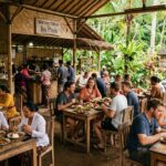 Best Food in Ubud: Top Culinary Spots You Can't Miss (2026) A wide outdoor shot of a bustling warung in Ubud, with locals and tourists eating at simple wooden tables.