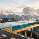 Luxury Alpin Panorama Hotel Hubertus: 2026 Guide to South Tyrol's Top Spa Hotel Rooftop infinity pool of Hotel Hubertus overlooking the Dolomites mountains.